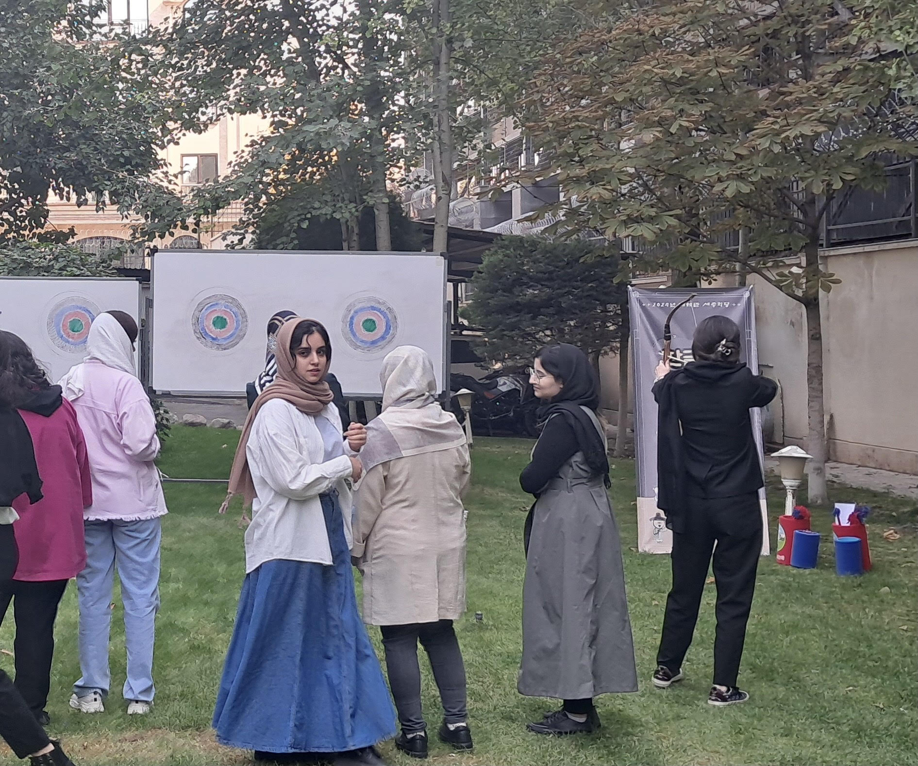 Audience practicing archery to get ready for the competition